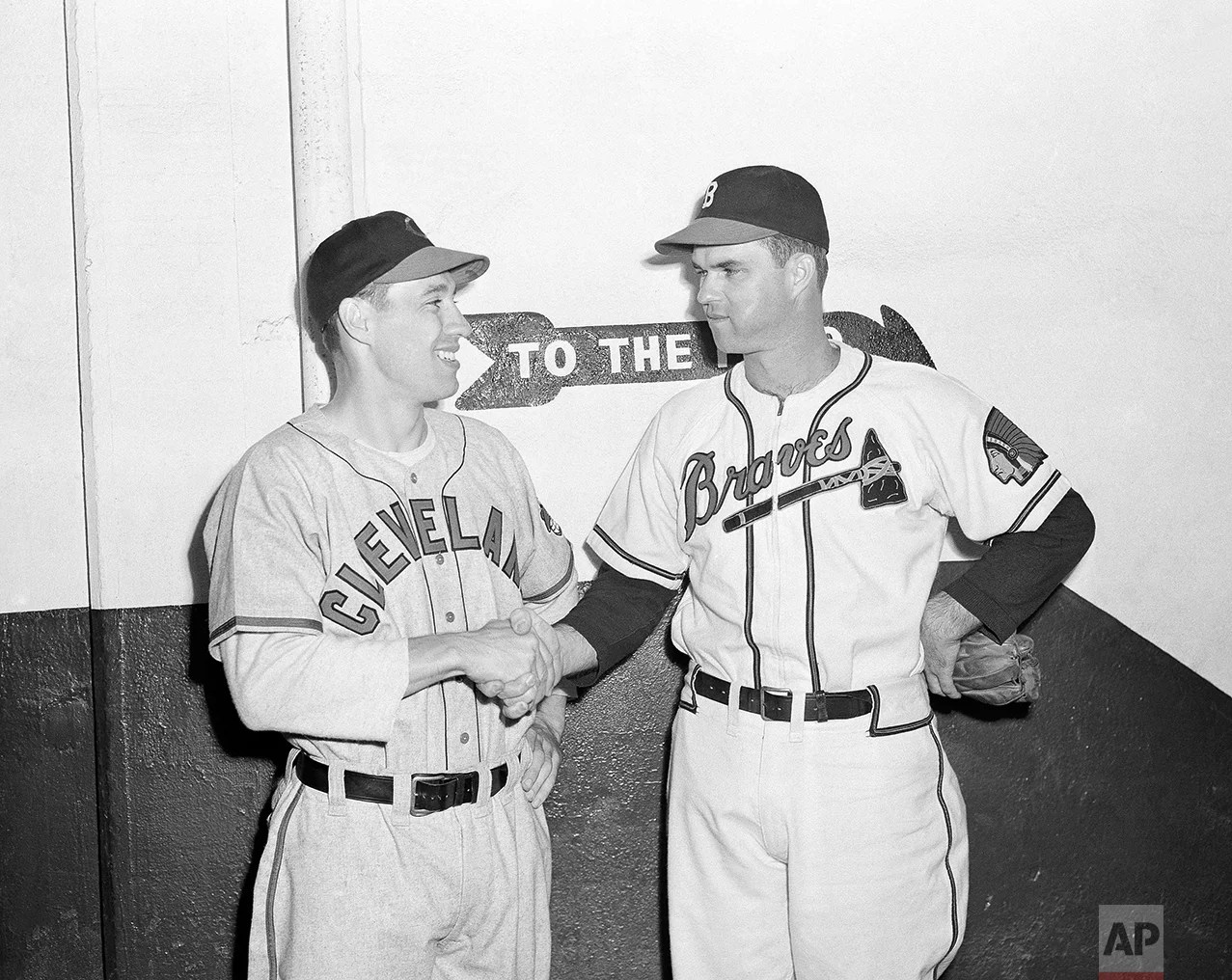 Johnny Sain, right, of the Boston Braves, shakes hands with Cleveland’s Bob Feller, before the two hurling aces took mound, Oct. 6, 1948 at Braves Field, Boston, for the opening game of the 1948 World Series. (AP Photo) 